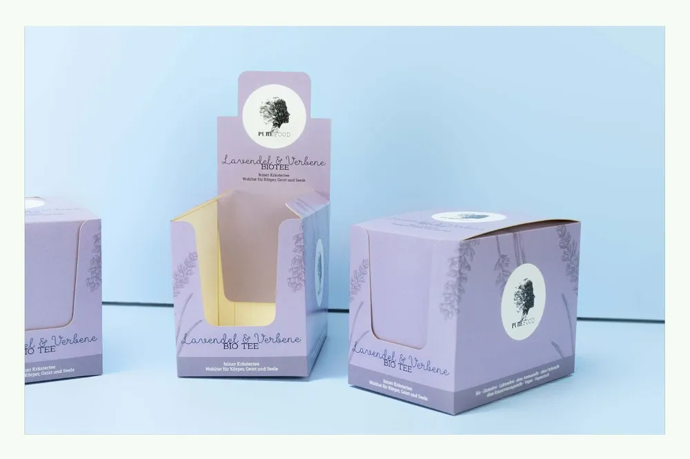 Diversi espositori da banco rosa in cartone, uno dei quali aperto Diversi espositori da banco rosa in cartone, uno dei quali aperto